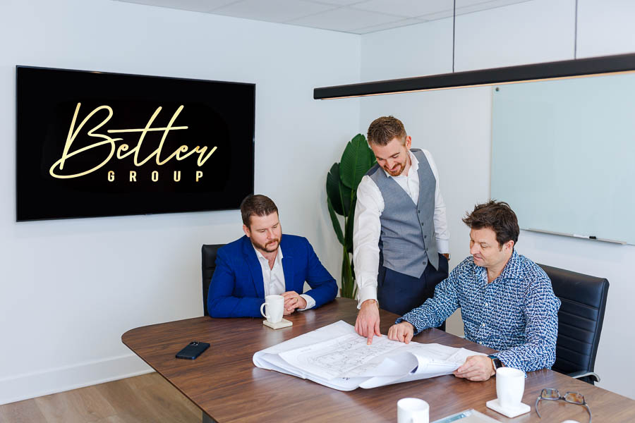 Commercial photography of co-founders Kyle Simourd and Kyle Soutar of Better Group presenting plans to show how they can help small and medium enterprises in Ottawa