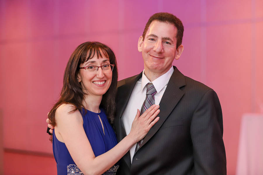 Parents embrace each other as they celebrate their daughter’s bat mitzvah party at Blu Legacy Convention Centre.