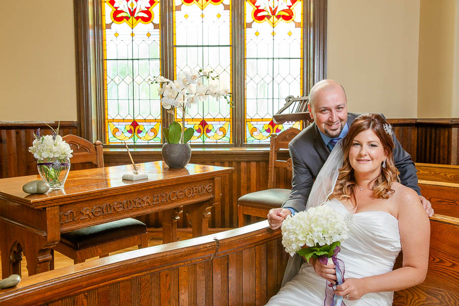 Bride and groom wedding portrait next to a white bridge gazebo at The Knox Wedding & Event Venue.