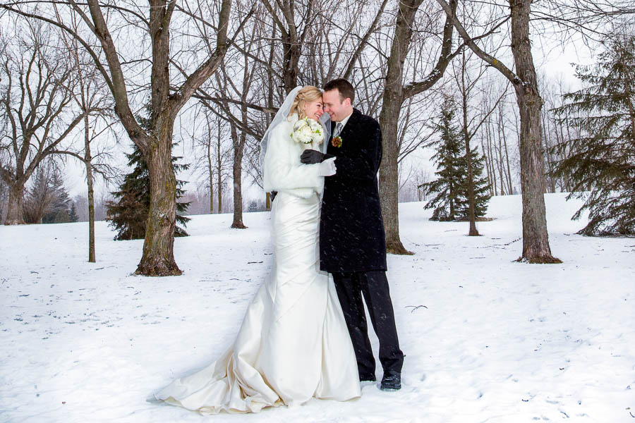 Joanne and Gabriel share a warm embrace during their outdoor winter wedding portraits in Manotick, Ontario.