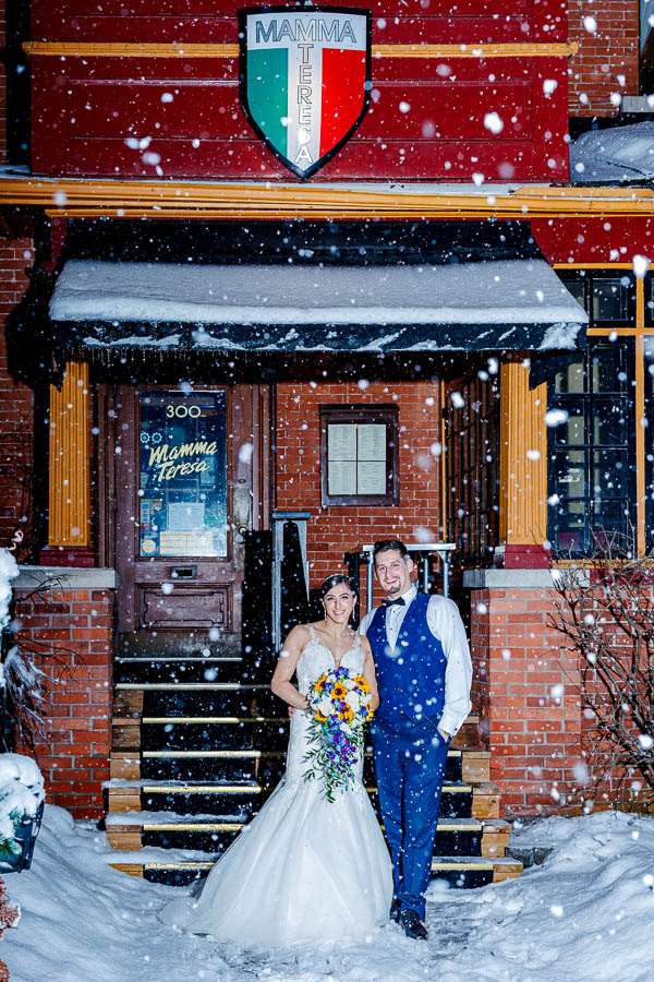 Maya & Mark break from their wedding reception at Mamma Teresa in Ottawa to take an outdoor winter wedding portrait with giant snowflakes falling.