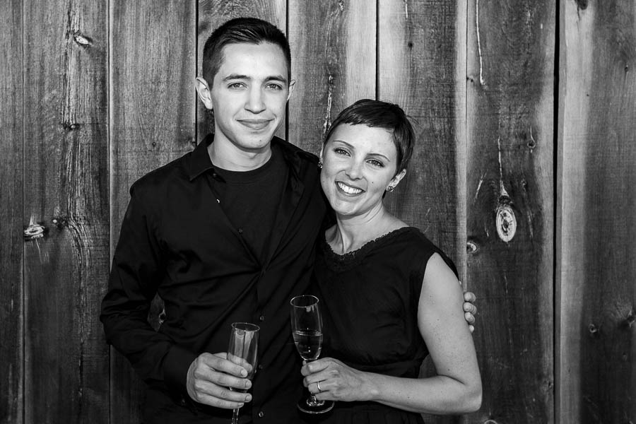 Rachel and Zach pose for a brother and sister family portrait against a barn door in Ottawa.